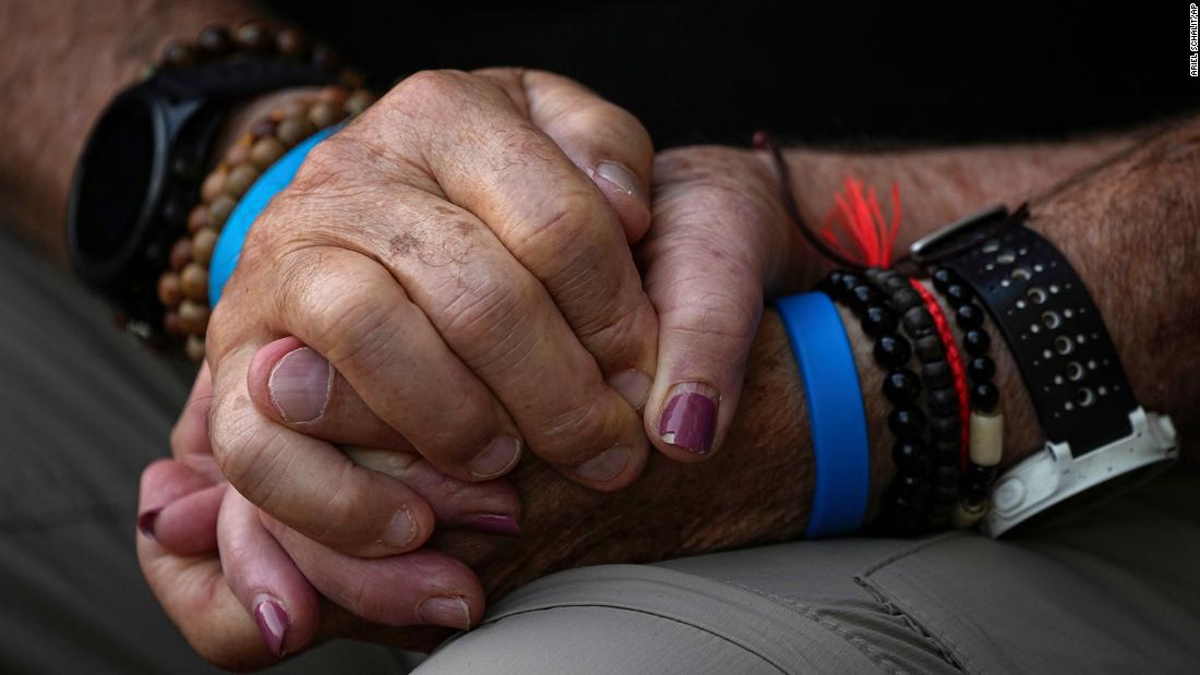 Mourners hold hands during the funeral of Sgt. Yam Goldstein and her father, Nadav, in Kibbutz Shefayim, Israel, on October 23.