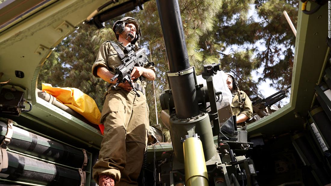 An Israeli soldier stands in an armored vehicle near the Lebanon border on October 23.