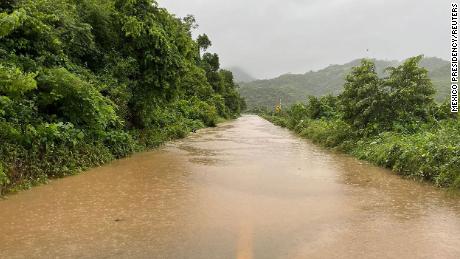 The highway that connects Chilpancingo with Acapulco is blocked Wednesday in the town of Juan R. Escudero, after the Papagayo River overflowed its banks due to heavy rains.