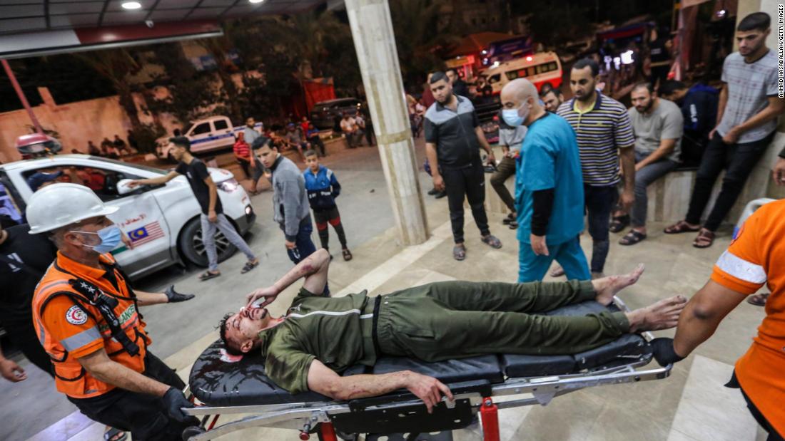 A Palestinian man injured in an Israeli airstrike is carried on a stretcher at Nasser Medical Hospital, in Khan Younis, Gaza, on October 27.
