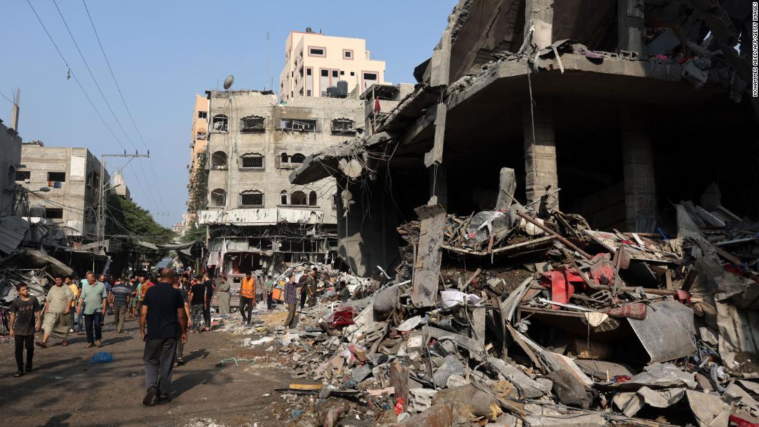 People check the destruction following Israeli strikes on Al-Shatee camp in Gaza City on October 28.