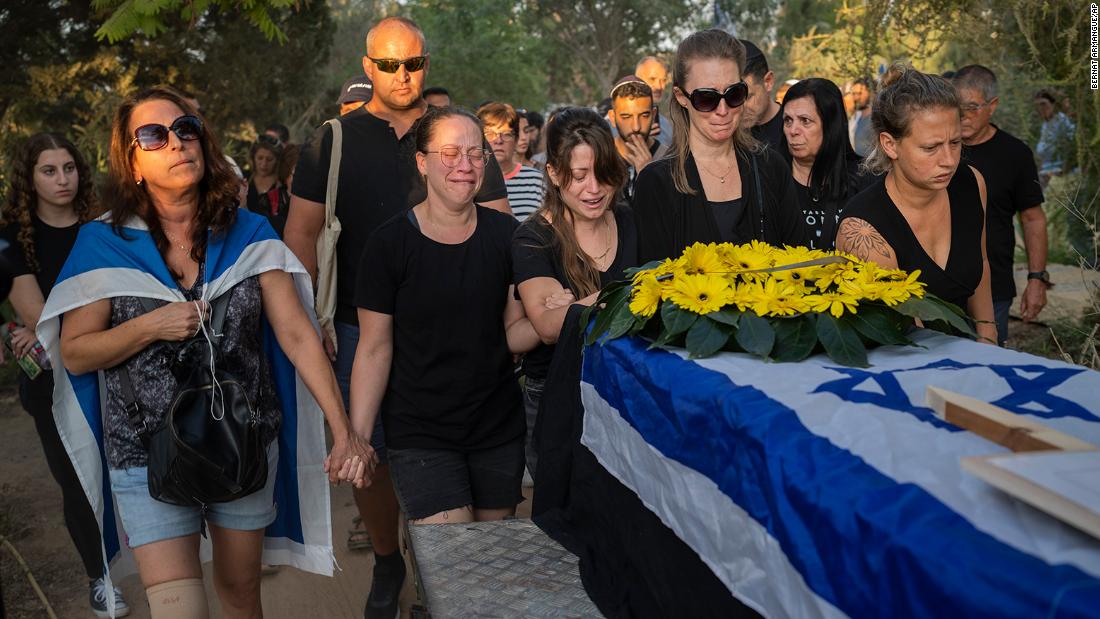 Relatives attend the funeral of Albert Miles, 81, at the Kibbutz Revivim cemetery, south Israel, on October 30. Albert Miles was killed during the Hamas attack on October 7, in Kibbutz Be&#39;eri near the border with Gaza.