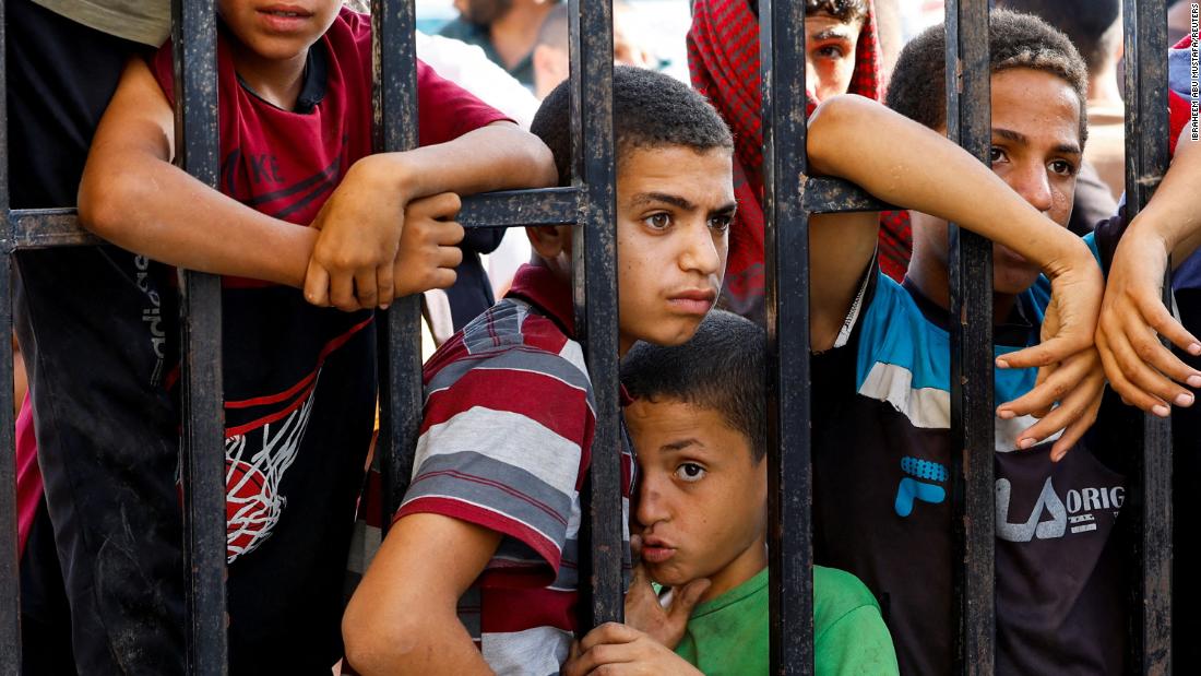 Children wait for the return of Palestinian workers from Israel at the Rafah border in southern Gaza, on November 3.