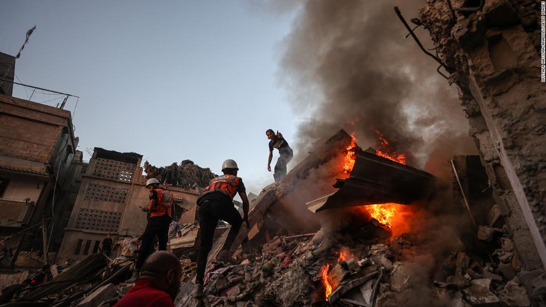 Teams put out a fire that broke out among the rubble of a destroyed building during search and rescue operations after an Israeli attack in Khan Younis, Gaza, on Saturday, November 4.