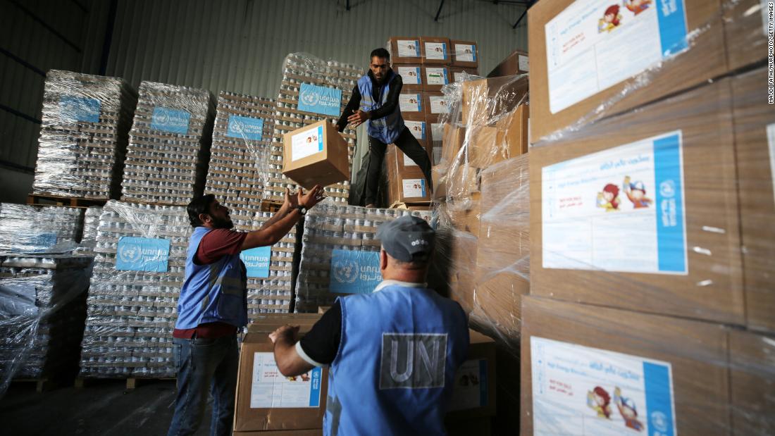 United Nations workers in the Nuseirat refugee camp in central Gaza prepare aid for distribution to Palestinians, who have fled their homes and are sheltering in a UN-run school, on November 4. 