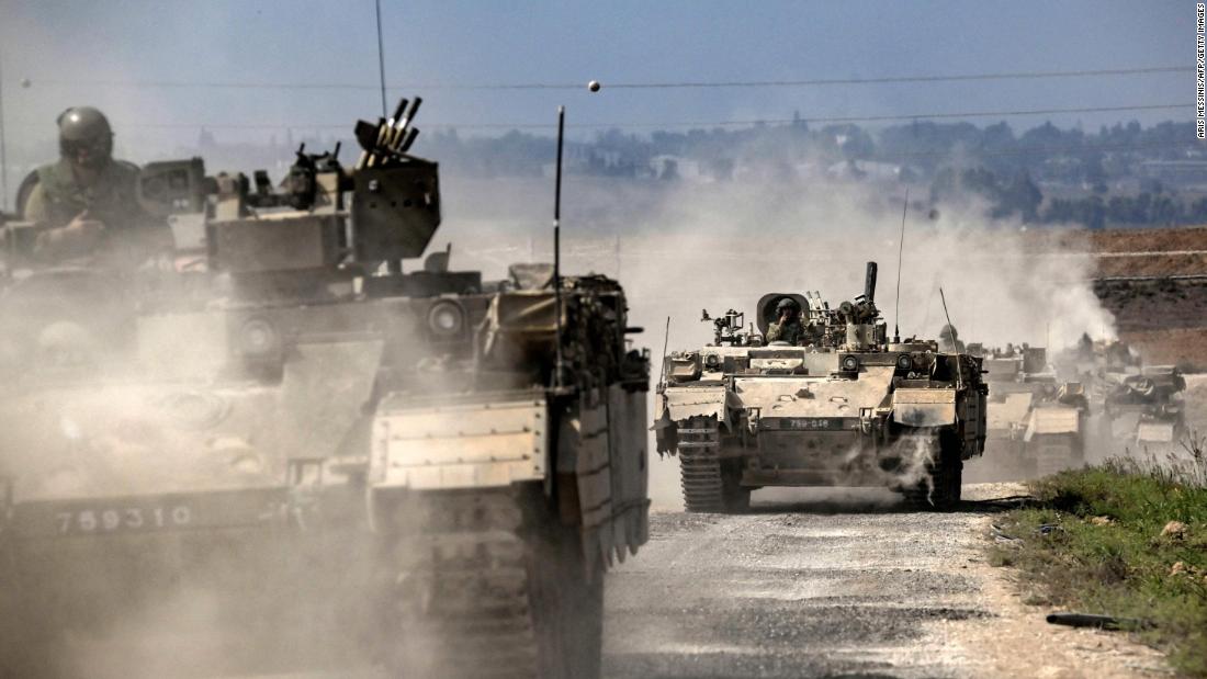 Israeli army Puma armored personnel carriers  move in a column near the Gaza border in southern Israel on October 14.