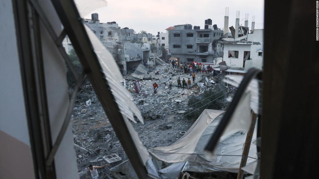 Palestinians look for survivors in the rubble after Israeli strikes in Rafah in southern Gaza on October 23.