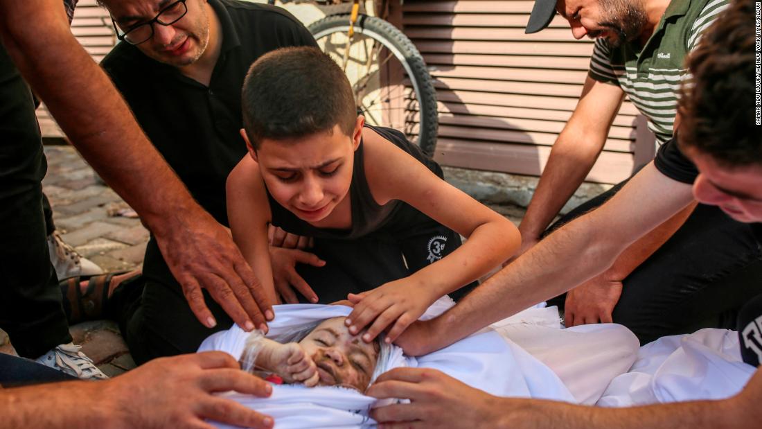 Khaled Joudeh mourns his young sister, Misq, at the morgue at Deir Al-Balah hospital in Gaza on October 22. 