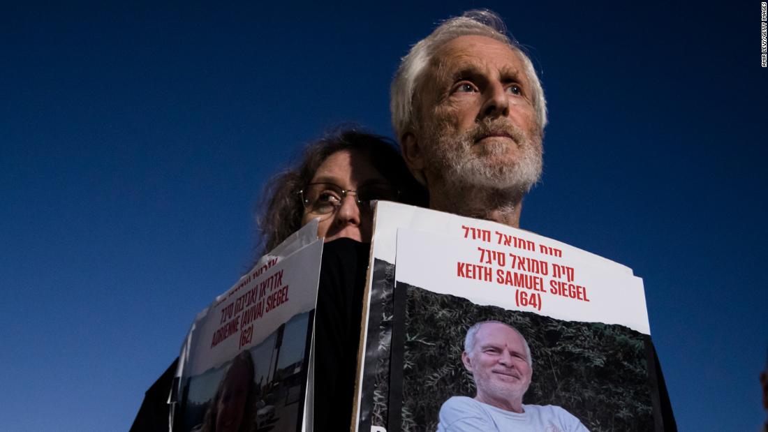 In Tel Aviv on November 7, people hold photos of people who were kidnapped by Hamas and taken to Gaza.