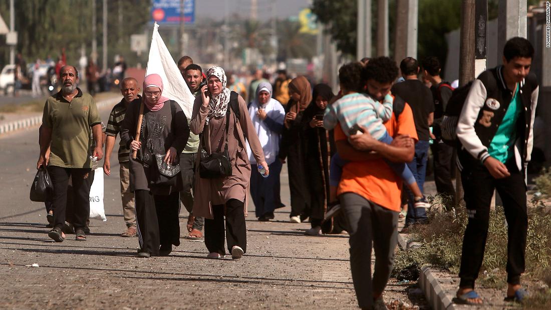A woman carries a white flag as Palestinians flee from Gaza City to the south on November 7.