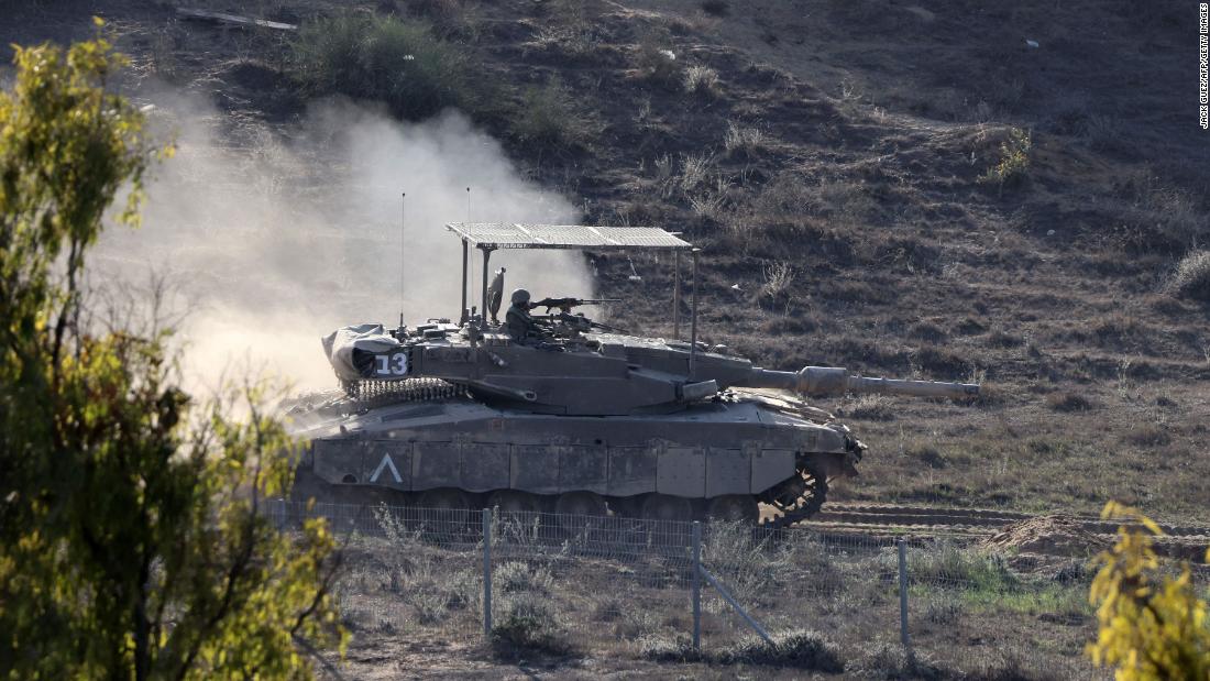 An Israeli tank rolls near Sderot, Israel, along the border with Gaza, on November 10.