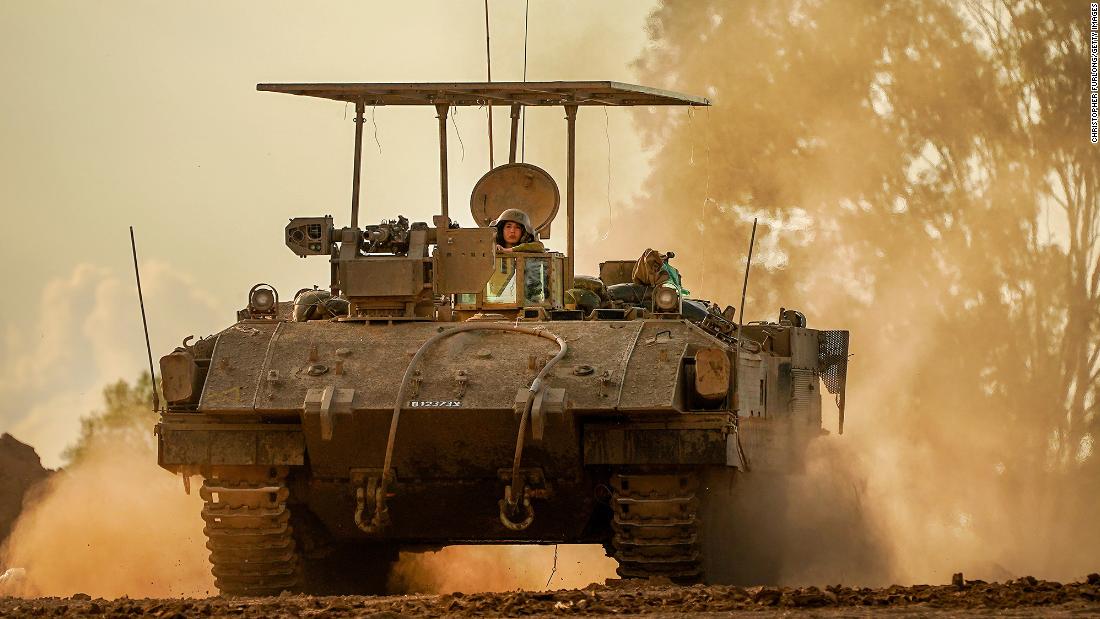 An Israeli army armored fighting vehicle returns to a staging area from the border with Gaza on November 15, in southern Israel.