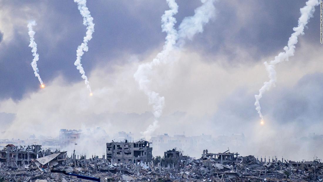 Smoke billows after an Israeli strike as flares are dropped over northern Gaza on November 22.