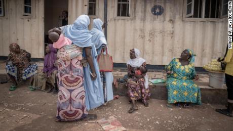 Women at the Durumi IDP camp, sitting on the veranda of the makeshift health post