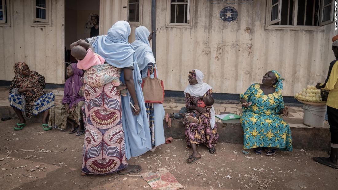 Women at the Durumi IDP camp, sitting on the veranda of the makeshift health post