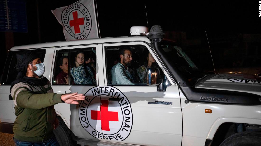 A Red Cross vehicle carrying Israeli hostages enters the Rafah border crossing late Saturday, November 25.