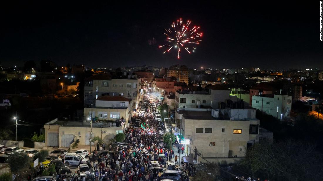 Fireworks streak across the sky as Palestinian prisoners who were released from the Israeli Ofer military facility are paraded in Beitunia, in the occupied West Bank, on November 24.