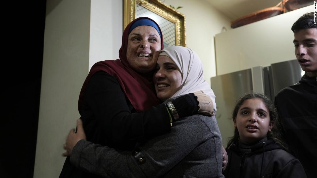 Israa Jaabis, left, a Palestinian prisoner released by Israel, is hugged as she arrives home in the East Jerusalem neighborhood of Jabel Mukaber early November 26.