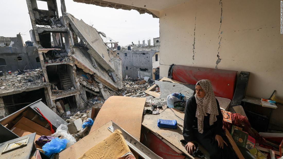 A Palestinian woman sits on debris in her damaged apartment in the Khezaa district on the outskirts of the southern Gazan city of Khan Younis on November 25. 