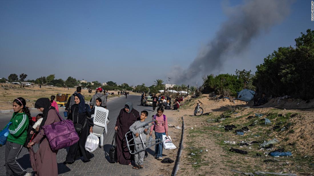 Palestinians carry belongings as they flee their homes on December 2, in Khan Younis, Gaza.