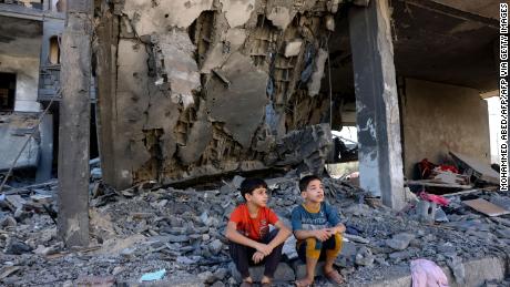 TOPSHOT - Children sit amid the rubble of a building in the aftermath of an Israeli strike in Rafah in the southern Gaza Strip on November 10, 2023, during ongoing battles between Israel and the Palestinian group Hamas. (Photo by Mohammed ABED / AFP) (Photo by MOHAMMED ABED/AFP via Getty Images)