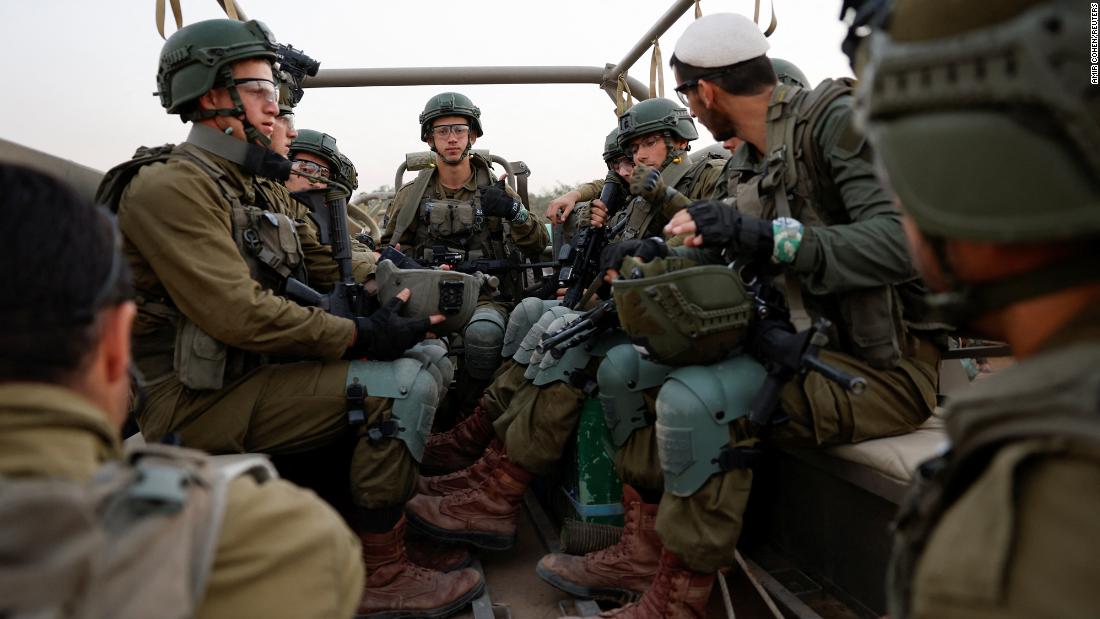 Israeli soldiers sit in a military vehicle near Israel&#39;s border with Gaza, in southern Israel, on December 4.