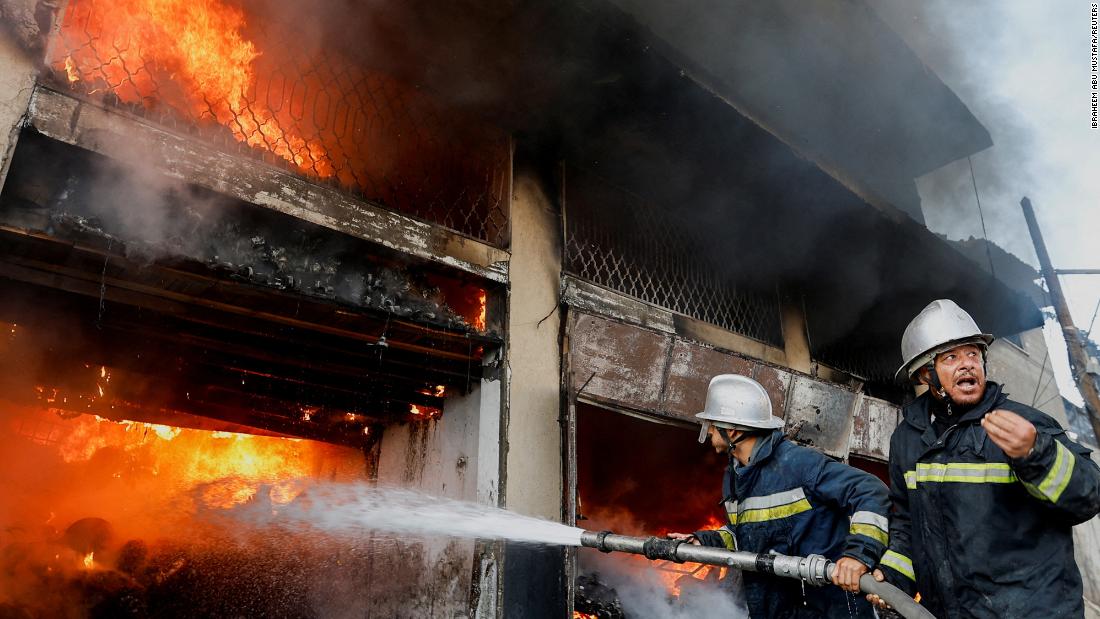 Palestinian firefighters work to extinguish a fire in a house after an Israeli strike in Khan Younis, Gaza, on December 9.