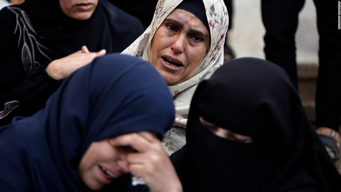 Palestinians mourn relatives killed in the Israeli bombardment of Gaza outside a morgue in Khan Younis on December 10.