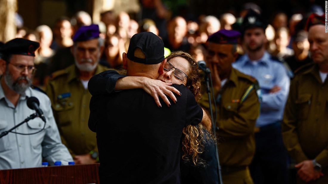 Mother and father of Israeli military commander Major Ben Shelly, who was killed in northern Gaza, embrace each other at his funeral in Kidron, Israel, on December 14.