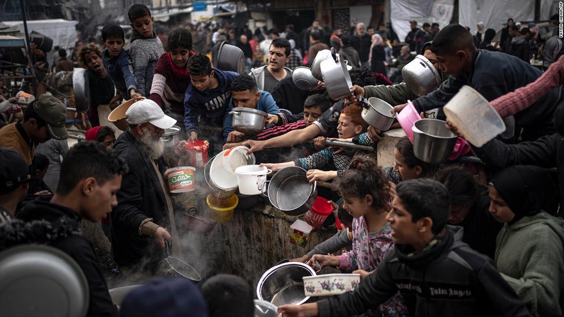 Palestinians converge for a free meal in Rafah, Gaza, on December 21.