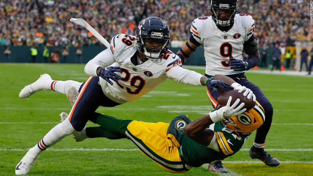 Green Bay Packers wide receiver Romeo Doubs can&#39;t quite pull in the catch while being defended by Chicago Bears cornerback Tyrique Stevenson on January 7. The Packers won 17-9 to clinch a playoff spot.