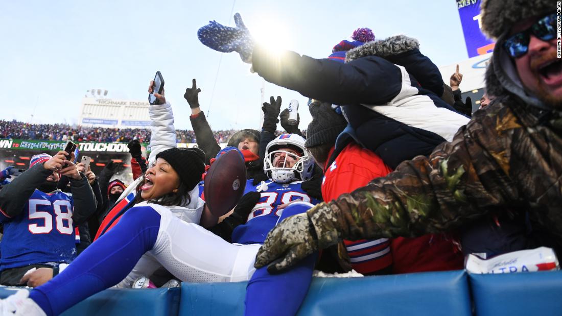 Buffalo Bills tight end Dawson Knox celebrates with fans after scoring a first-half touchdown against Pittsburgh on January 15. The Bills won 31-17.