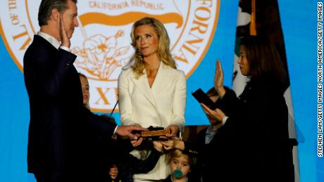 SACRAMENTO, CA - JANUARY 07: Gavin Newsom (L) is sworn in as governor of California by California Chief Justice Tani Gorre Cantil-Sakauye (R) as Newsom&#39;s wife, Jennifer Siebel Newsom (C), watches on January 7, 2019 in Sacramento, California. Gavin Newsom will begin his first term as the 40th governor of California after serving as the 42nd Mayor of San Francisco as well as Lieutenant Governor of California since 2010 alongside outgoing governor Jerry Brown (Photo by Stephen Lam/Getty Images)