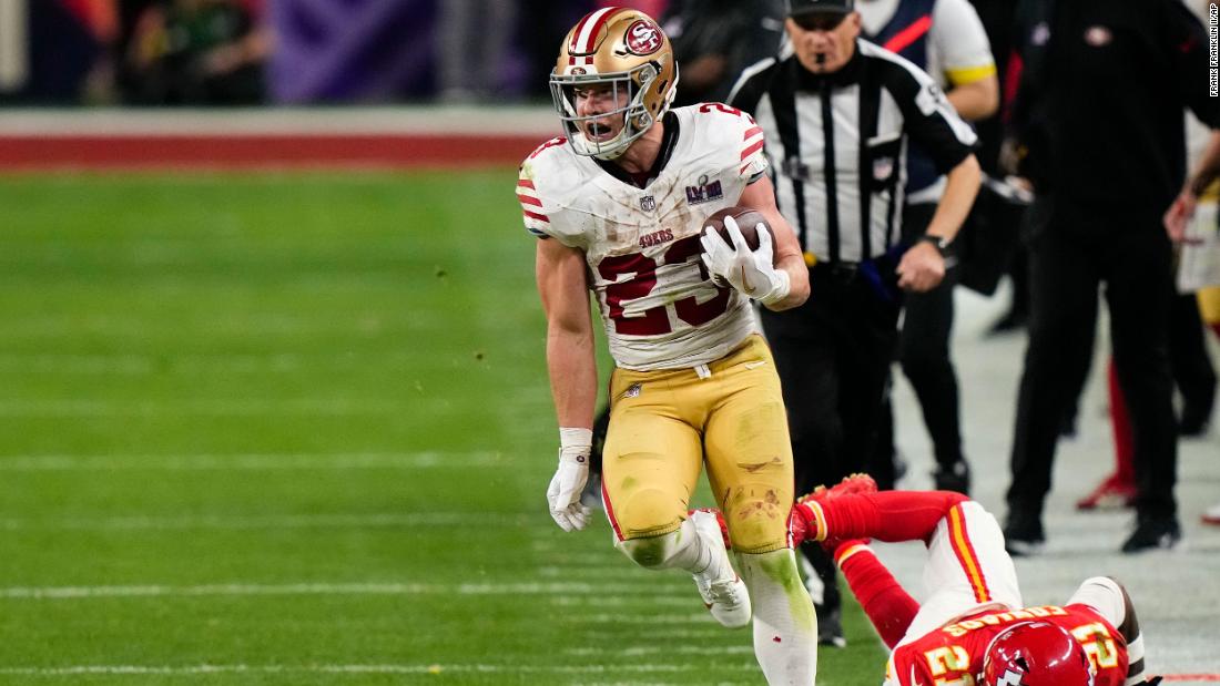 49ers running back Christian McCaffrey runs down the sideline for a big gain during overtime. The play set up a Jake Moody field goal that gave the 49ers a 22-19 lead.