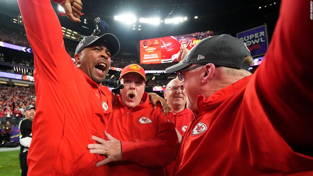 Chiefs head coach Andy Reid, second left, celebrates with staff members after the game.