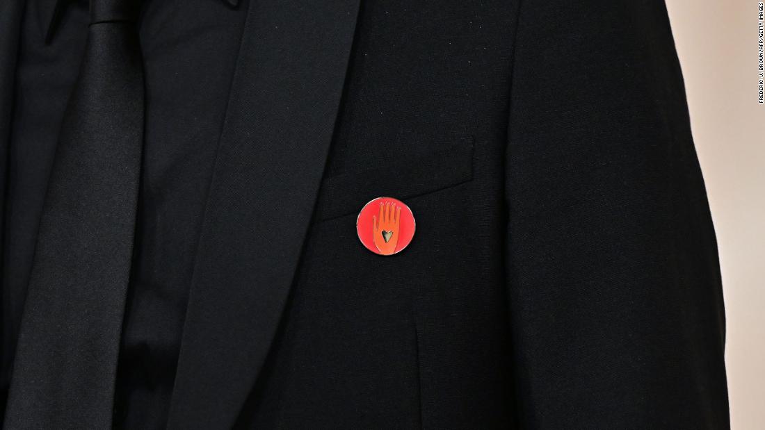 Film producer Nadim Cheikhrouha wears a red lapel pin on the red carpet. The same pin was also seen on Ramy Youssef, Mark Ruffalo and Billie Eilish. &lt;a href=&quot;https://www.cnn.com/entertainment/live-news/oscars-academy-awards-03-10-24/h_e1d87d22f44731c0aefccb26fe997660&quot; target=&quot;_blank&quot;&gt;The pins call for a ceasefire&lt;/a&gt; in the Israel-Hamas war.