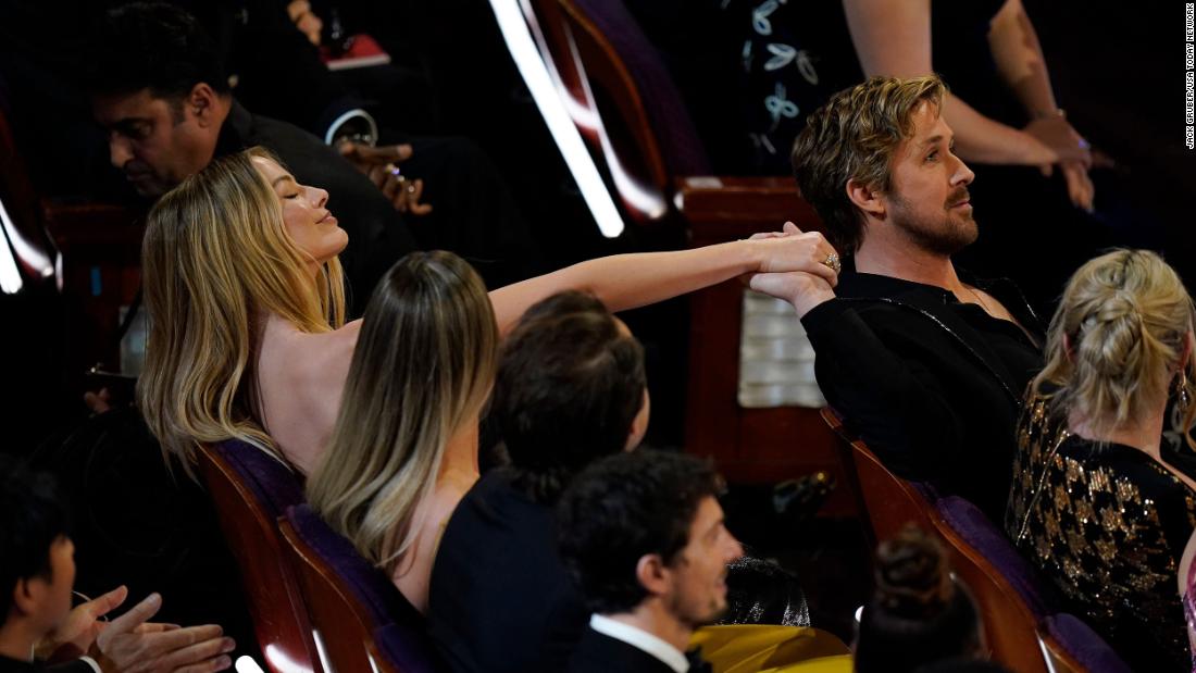 Gosling and &quot;Barbie&quot; co-star Margot Robbie hold hands during the show.