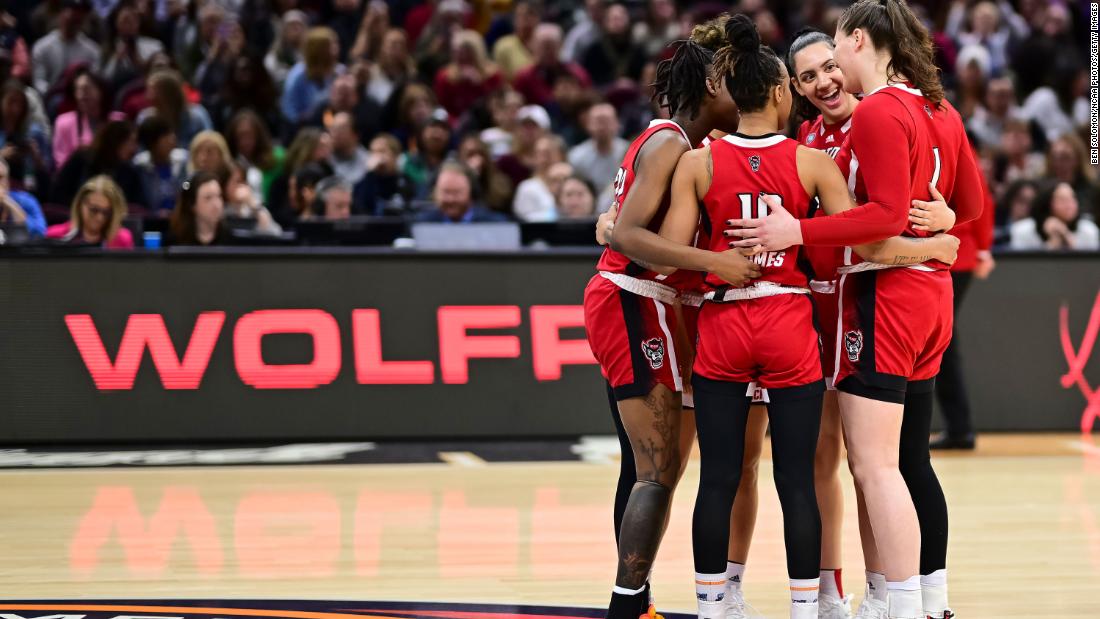 NC State Wolfpack players huddle together before tipoff.