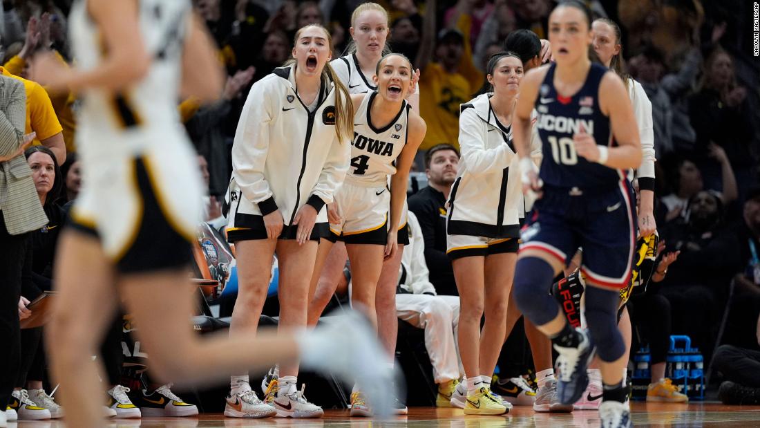 Iowa players react from the bench during the second half.