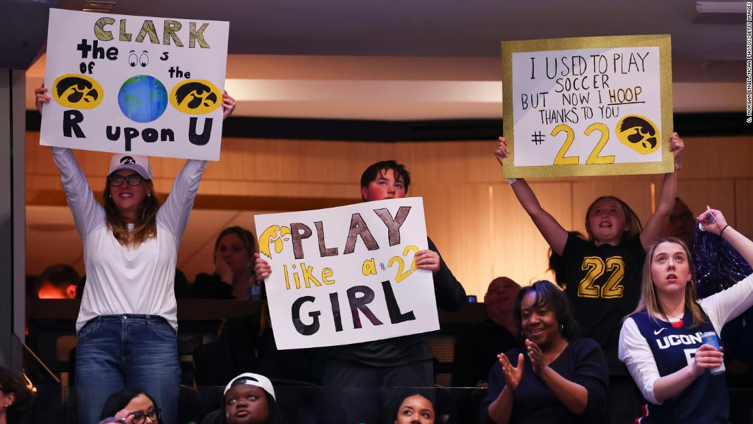 Iowa Hawkeyes fans hold up signs during the game.