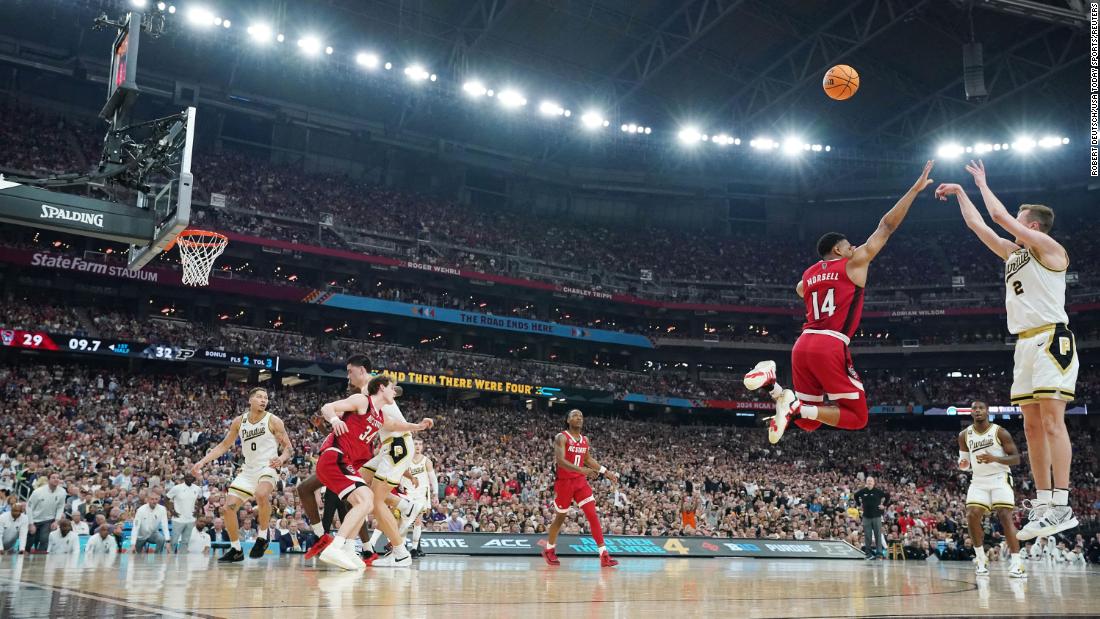 Loyer shoots over NC State guard Casey Morsell.