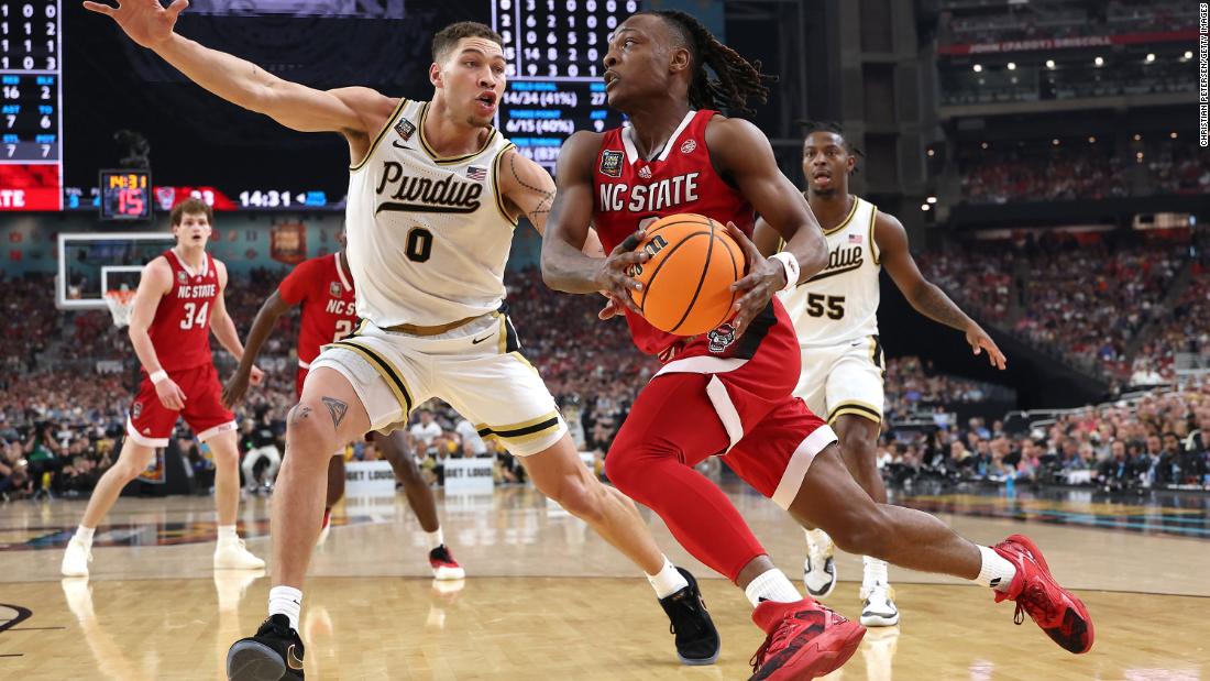 DJ Horne of NC State dribbles the ball past Purdue&#39;s Mason Gillis. 