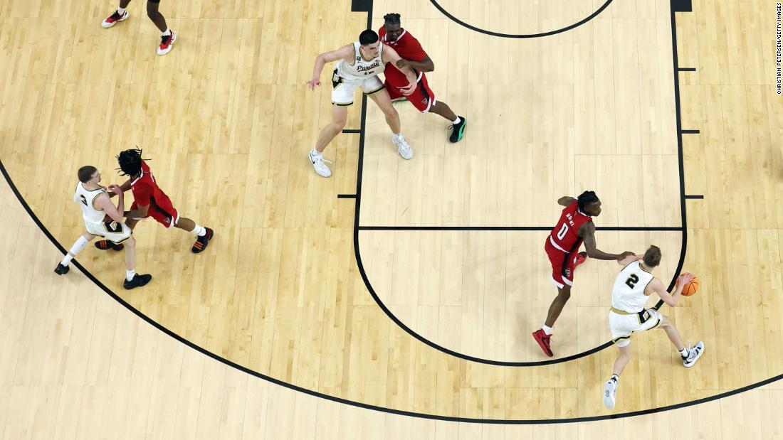 Loyer dribbles the ball toward the basket. 