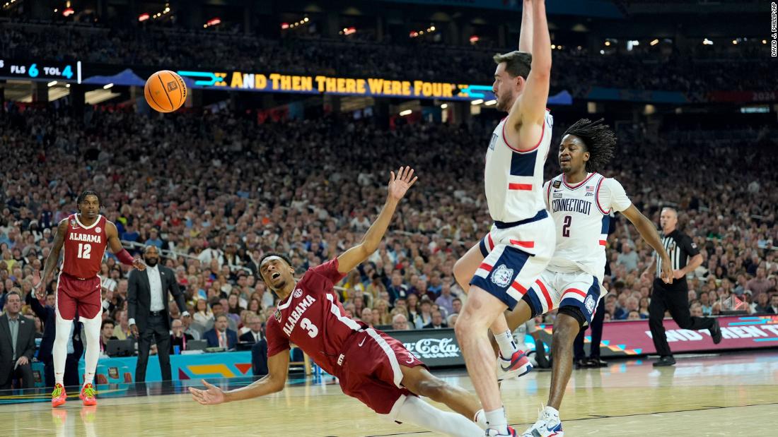 UConn forward Alex Karaban fouls Alabama guard Rylan Griffen in the first half.