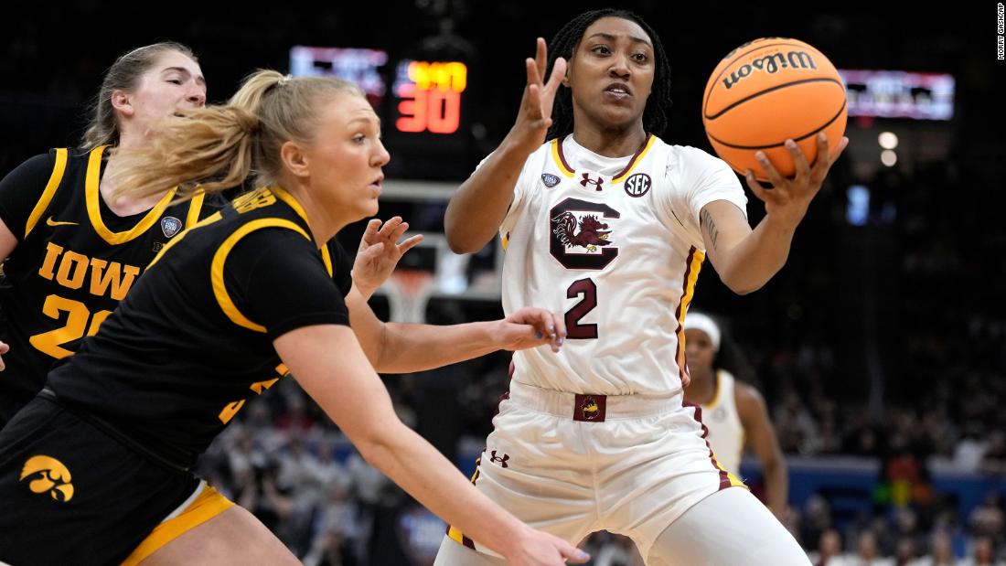South Carolina forward Watkins fights for a rebound with Iowa guard Sydney Affolter, left.