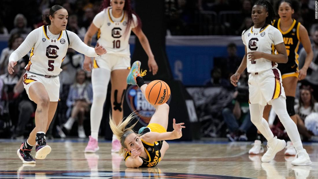 Iowa guard Kylie Feuerbach, center, fights for a loose ball with South Carolina guards Tessa Johnson, left, and Fulwiley, right.