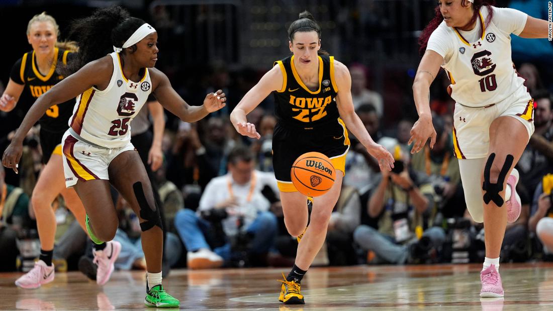 Clark runs down a loose ball between South Carolina guard Raven Johnson and center Cardoso.