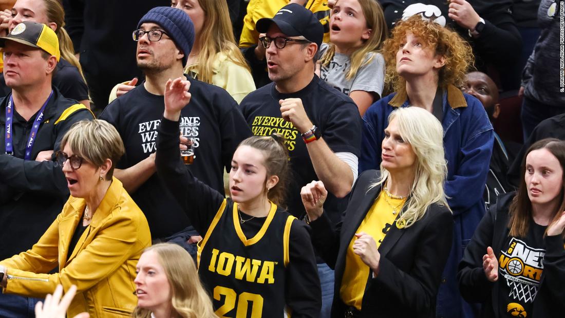 Actor Jason Sudeikis, center, watches the game.