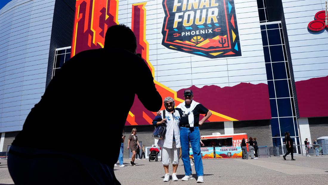 Fans pose for photos outside State Farm Stadium prior to the game.