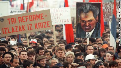A demonstrator holds a portrait of Serbian Communist Party leader Slobodan Milosevic in Belgrade as thousands of people head for a Serbian nationalist rally on 19th November 1988, only hours after ethnic Albanians took to the streets in Serbian&#39;s autonomous province of Kosovo to protest Serbian repression. Milosevic was campaigning to abolish the autonomous status of Kosovo. (Photo credit should read PATRICK HERTZOG/AFP via Getty Images)
